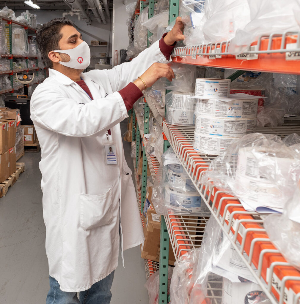 Vitaquest warehouse tech inspecting supplement packaging labels