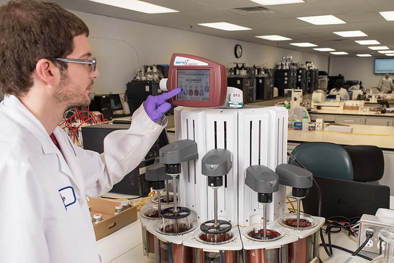 Lab technician conducting quality checks in Vitaquest lab.